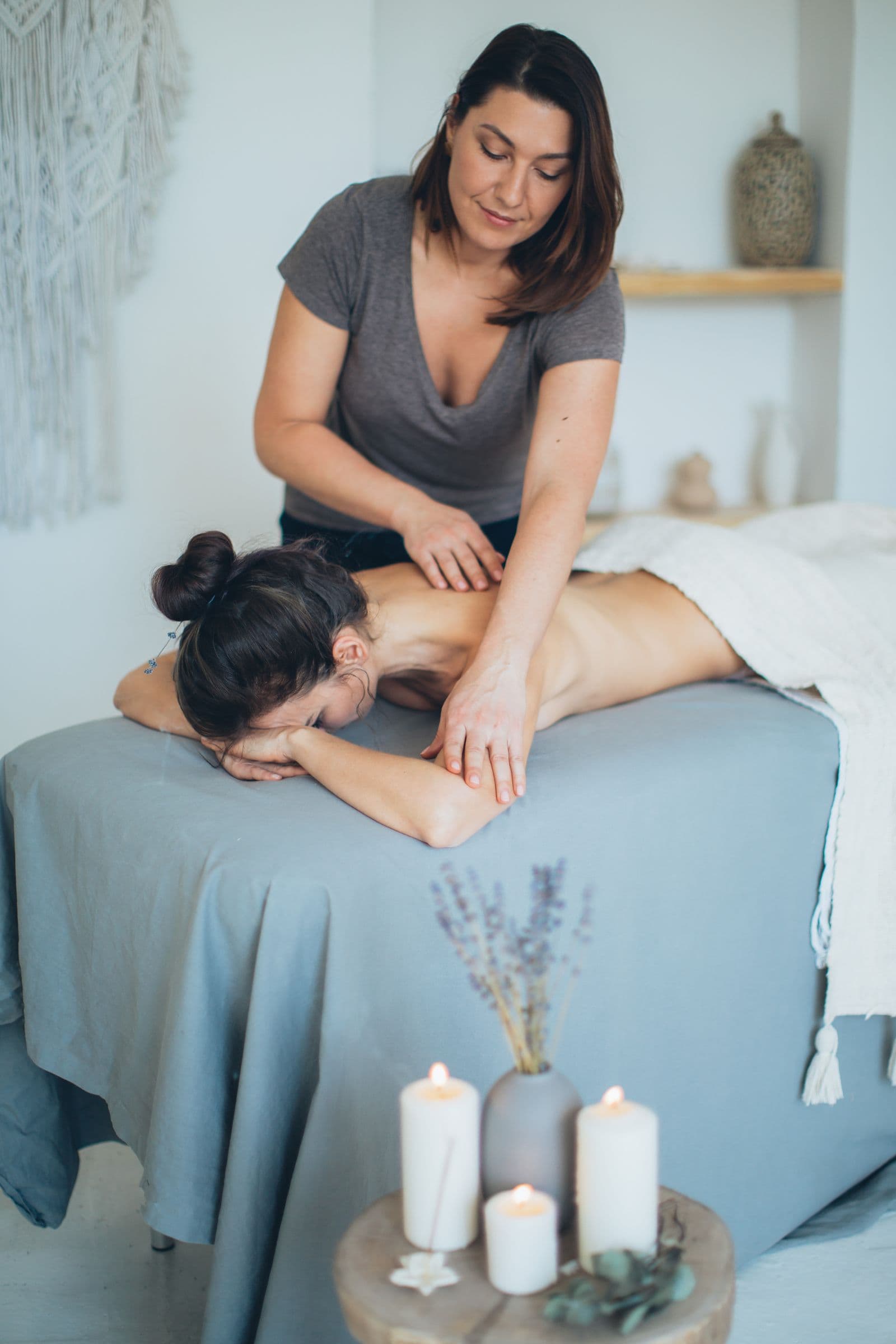 Remedial massage therapist treating a client in a calm clinic room