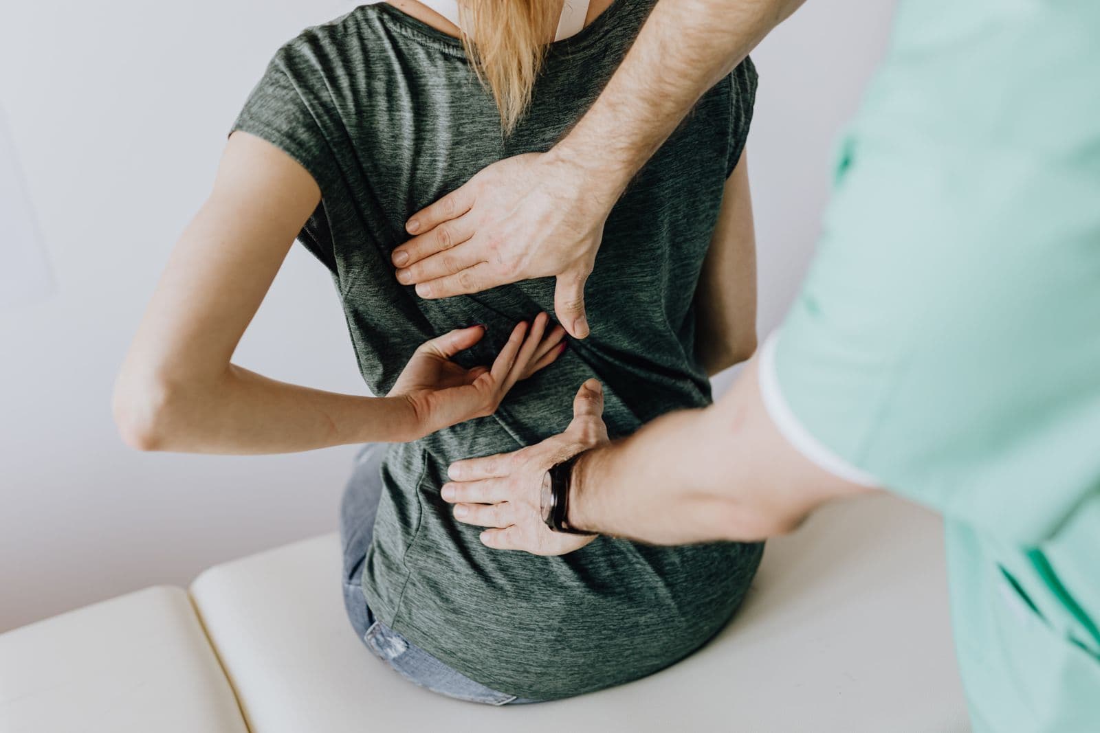 Therapist assessing a client's posture before remedial treatment